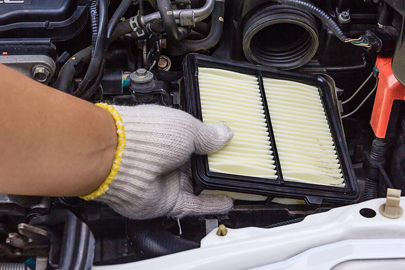 Technician replacing an air filter.