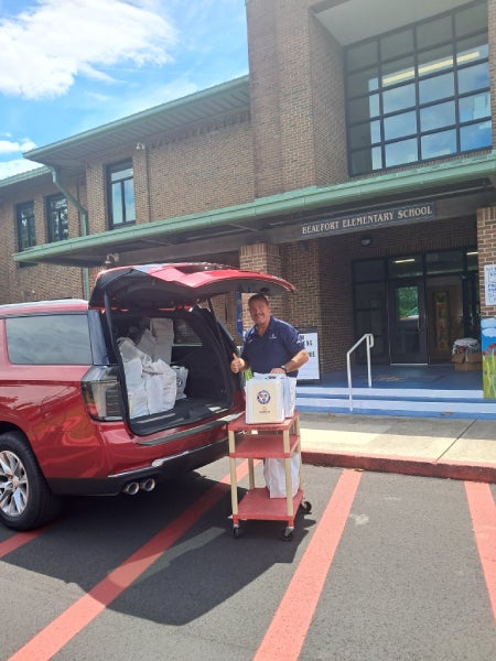Vaden team loading school supply bags into an SUV