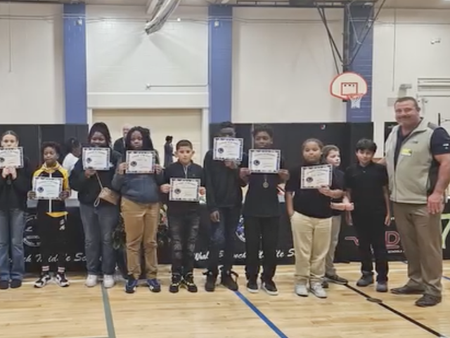 Children standing with certificates