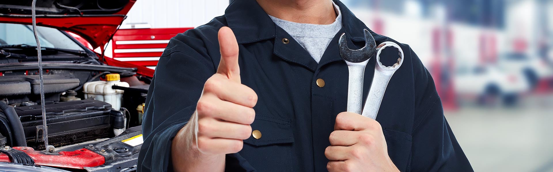 Five stars WordPressFive stars WordPressFive stars WordPressFive stars WordPressFive stars WordPress
Mechanic in workshop giving thumbs-up, holding wrenches, with car engine in background